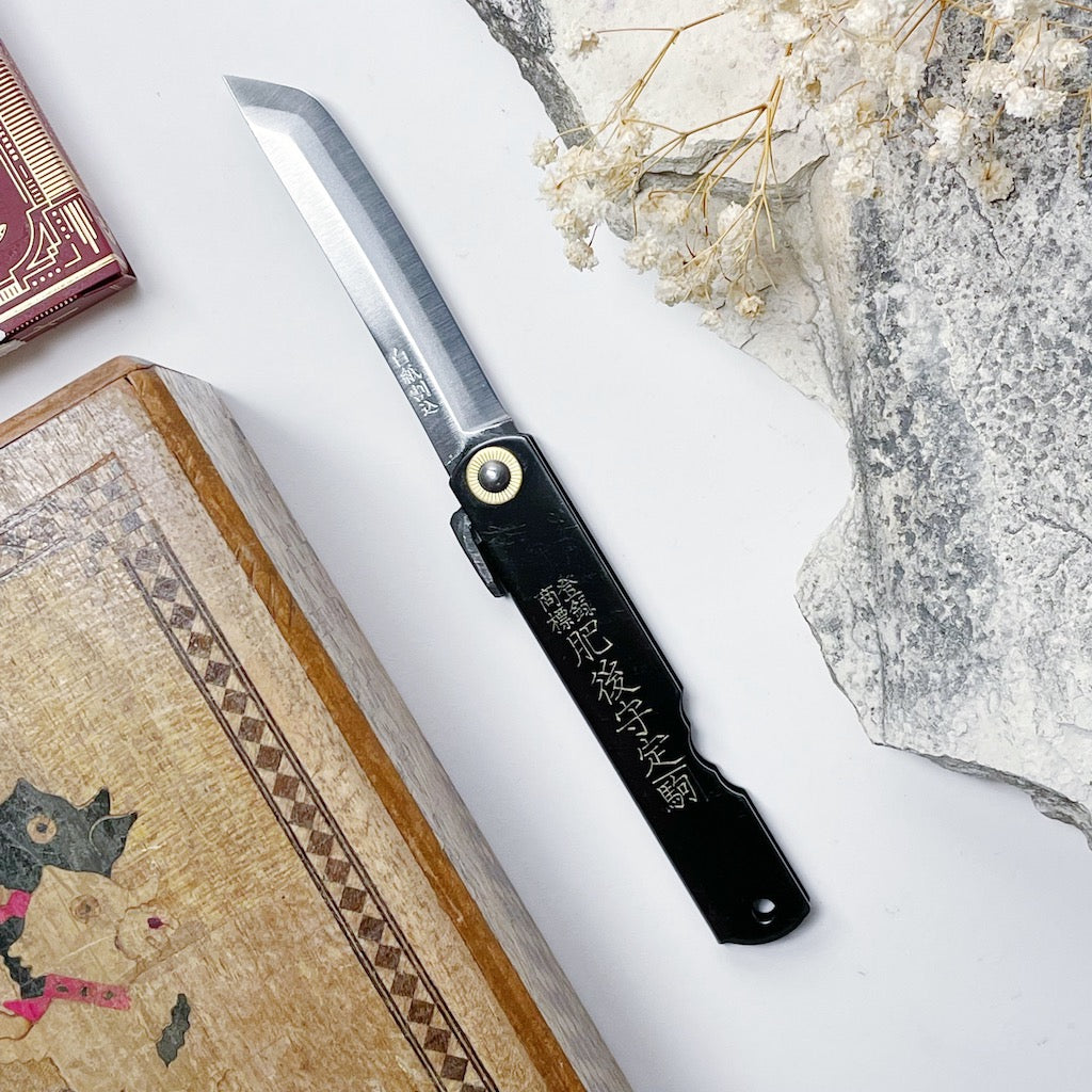 http://topshelfworldwide.com/cdn/shop/products/HigonokamiKen-GataSwordShapeBlackFoldingPocketKnife-1.jpg?v=1647928125